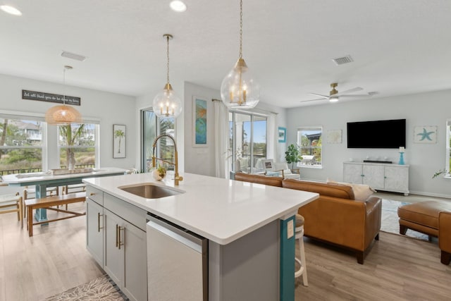 57 Guanahani Trl, Saint Augustine, FL 32080 - kitchen with dishwashing machine, light countertops, an island with sink, light wood-type flooring, and recessed lighting
