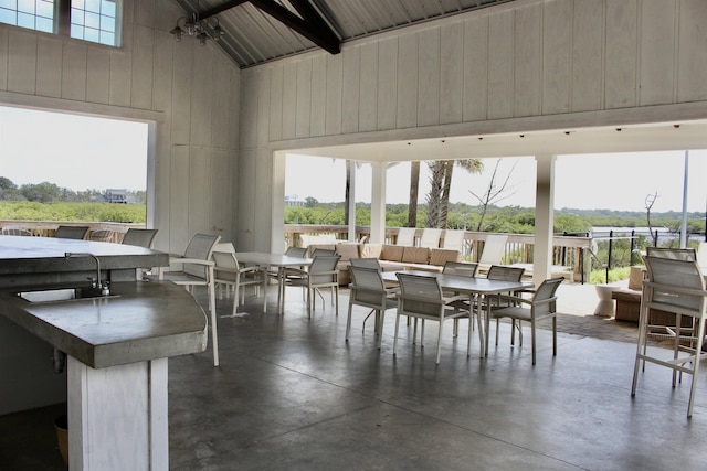 57 Guanahani Trl, Saint Augustine, FL 32080 - dining area featuring high vaulted ceiling, finished concrete floors, and wood walls