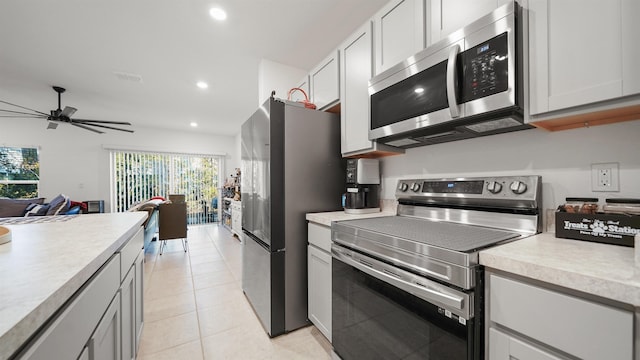 kitchen featuring white cabinetry, light tile patterned floors, ceiling fan, and appliances with stainless steel finishes