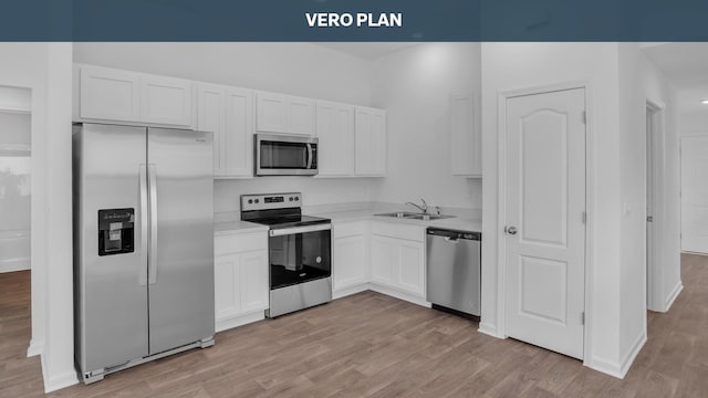 kitchen with sink, white cabinets, stainless steel appliances, and light hardwood / wood-style floors