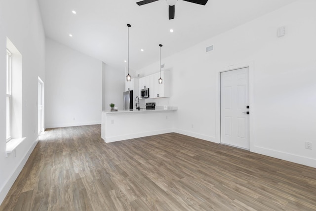 441 S Woodlawn St, Saint Augustine, FL 32084 - unfurnished living room featuring high vaulted ceiling, a ceiling fan, wood finished floors, and recessed lighting