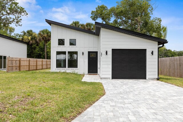 441 S Woodlawn St, Saint Augustine, FL 32084 - view of front of house with an attached garage, decorative driveway, and board and batten siding