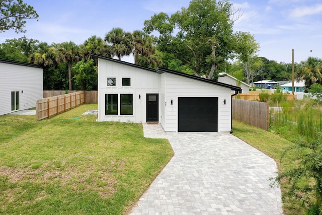 441 S Woodlawn St, Saint Augustine, FL 32084 - view of front facade with board and batten siding, decorative driveway, and a garage