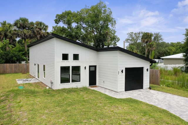 441 S Woodlawn St, Saint Augustine, FL 32084 - modern farmhouse style home featuring an attached garage, decorative driveway, and board and batten siding