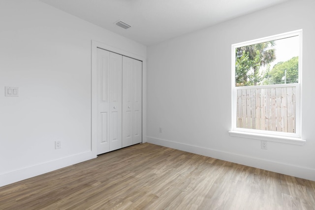 441 S Woodlawn St, Saint Augustine, FL 32084 - unfurnished bedroom with wood finished floors and a closet