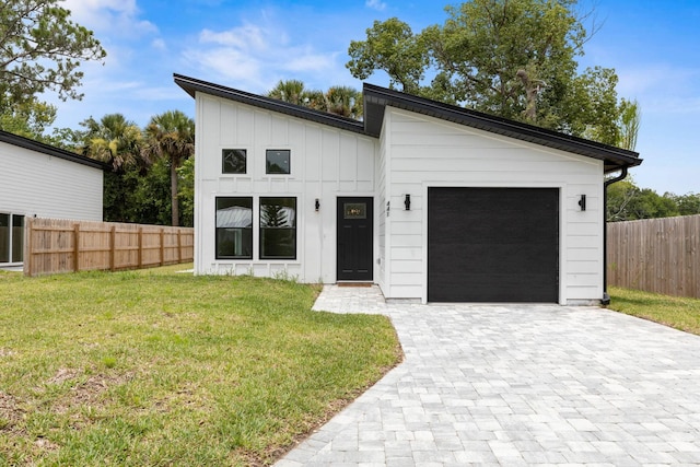 441 S Woodlawn St, Saint Augustine, FL 32084 - view of front of house with an attached garage, decorative driveway, and board and batten siding