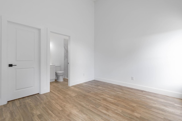 441 S Woodlawn St, Saint Augustine, FL 32084 - unfurnished bedroom featuring light wood-style flooring and connected bathroom