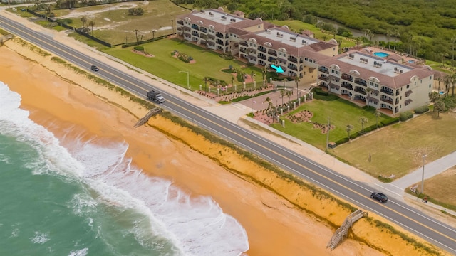 bird's eye view with a water view and a beach view