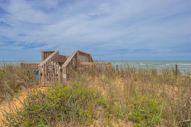 exterior space with a water view and a view of the beach