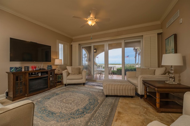 tiled living room featuring ceiling fan, a healthy amount of sunlight, and ornamental molding