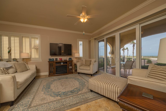 living room featuring ceiling fan, a fireplace, and crown molding