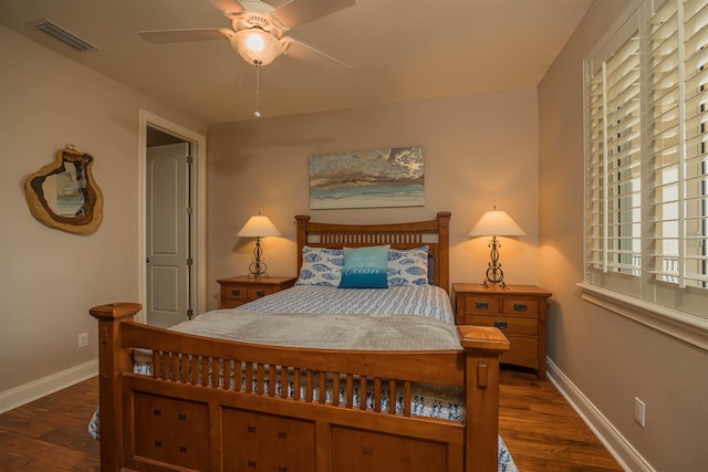 bedroom with dark hardwood / wood-style floors, ceiling fan, and multiple windows