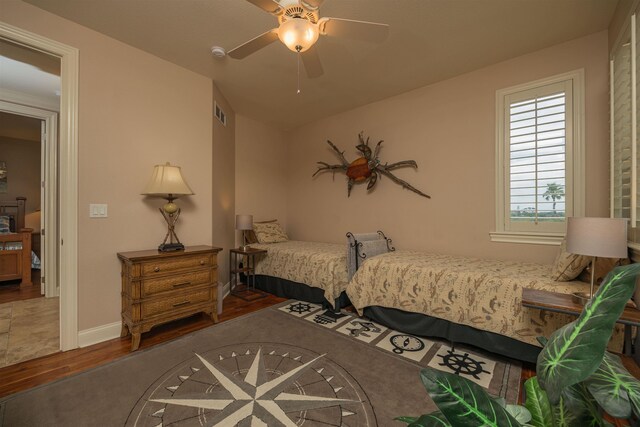 bedroom with ceiling fan and hardwood / wood-style floors