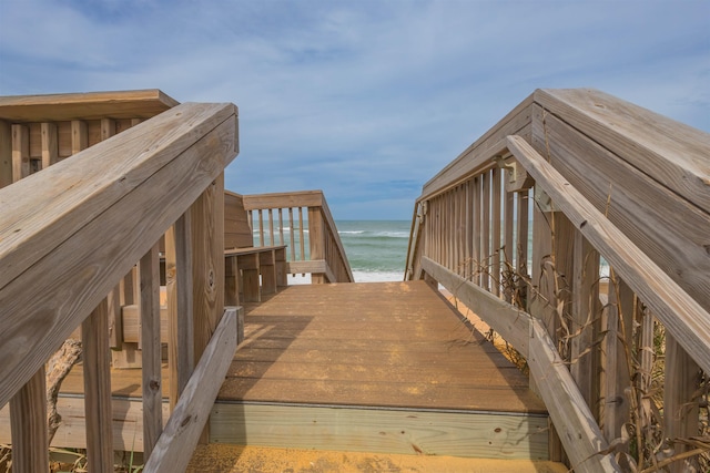 view of home's community featuring a beach view and a water view