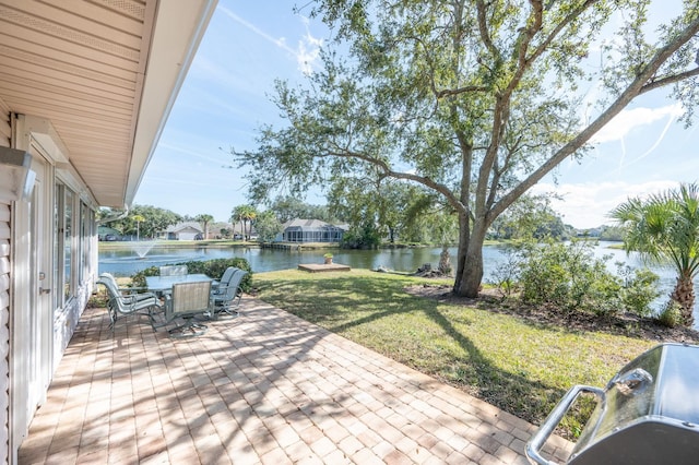 view of patio featuring outdoor dining area and a water view