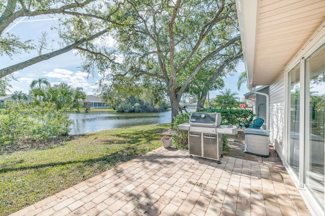 view of patio / terrace featuring a water view and a grill
