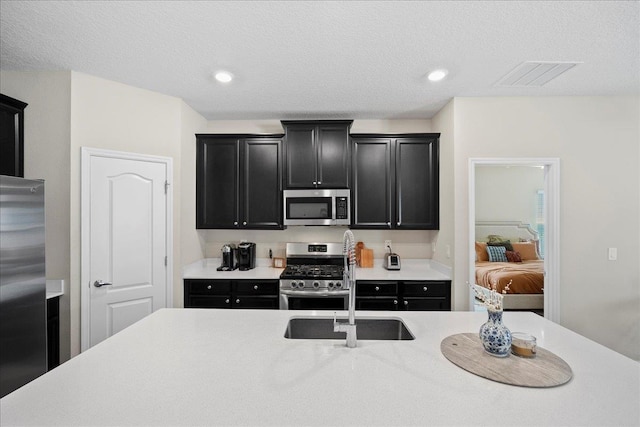 34 Anguilla Blvd, Saint Augustine, FL 32092 - kitchen featuring stainless steel appliances, dark cabinets, light countertops, recessed lighting, and a textured ceiling