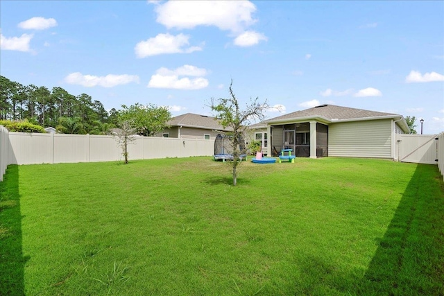 34 Anguilla Blvd, Saint Augustine, FL 32092 - fenced backyard featuring a trampoline, a sunroom, and a gate