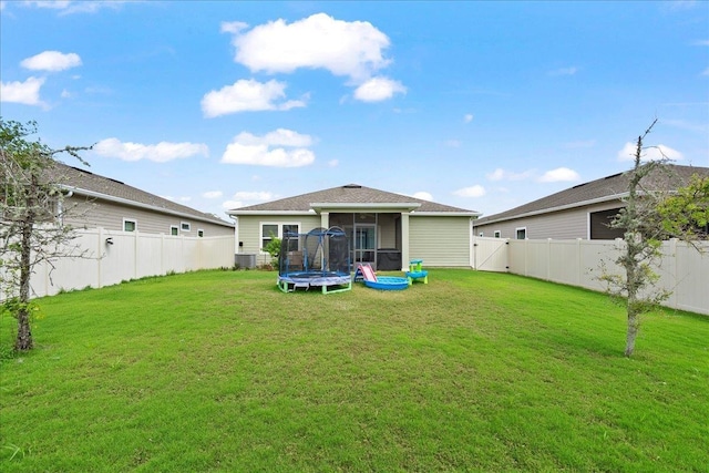 34 Anguilla Blvd, Saint Augustine, FL 32092 - rear view of property featuring a trampoline, a sunroom, and a fenced backyard