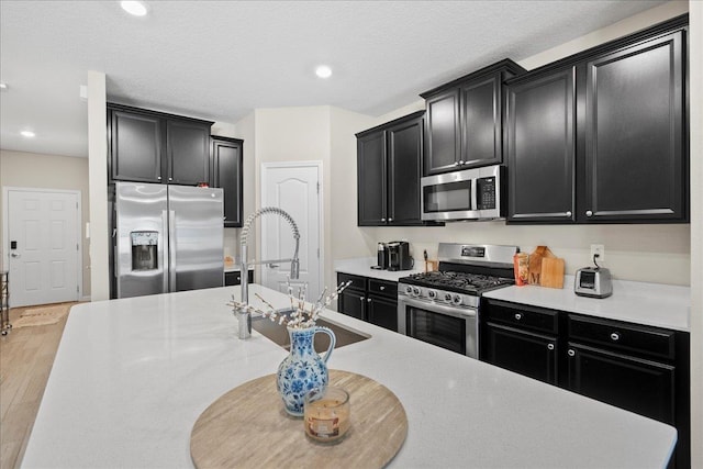 34 Anguilla Blvd, Saint Augustine, FL 32092 - kitchen with stainless steel appliances, dark cabinets, light countertops, and recessed lighting