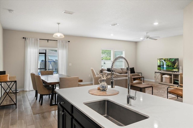 34 Anguilla Blvd, Saint Augustine, FL 32092 - kitchen with open floor plan, dark cabinetry, light wood-style flooring, recessed lighting, and hanging light fixtures