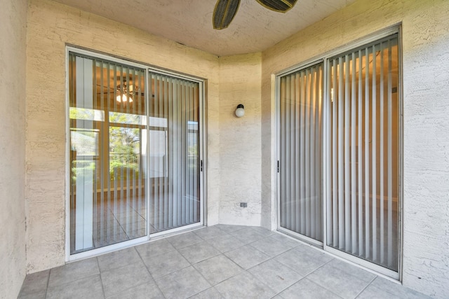 doorway to property featuring stucco siding and a patio area