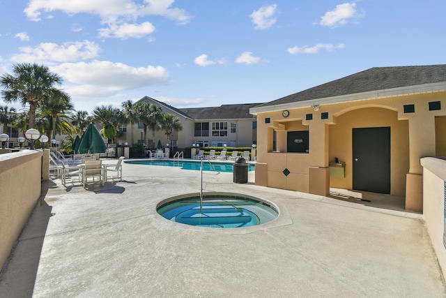 community pool with a community hot tub and a patio