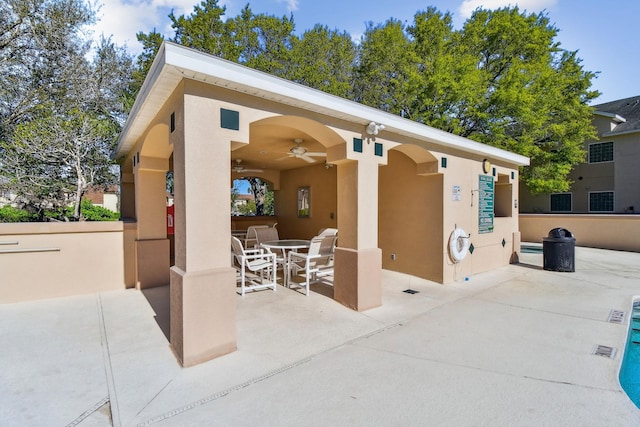 view of patio with outdoor dining area and a ceiling fan