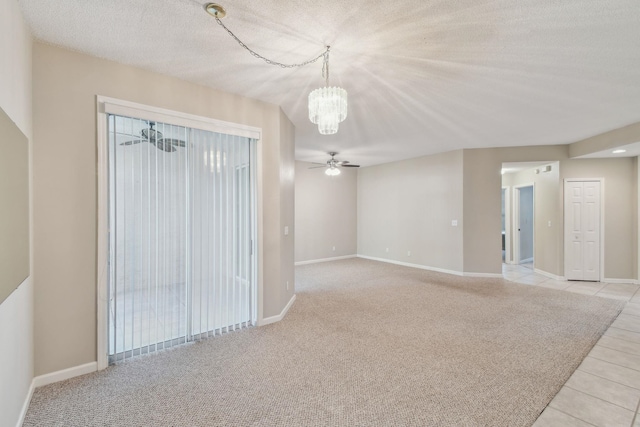 unfurnished room with light colored carpet, baseboards, a textured ceiling, and ceiling fan with notable chandelier