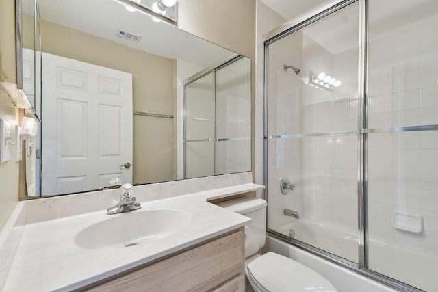 full bath featuring vanity, toilet, visible vents, and shower / bath combination with glass door