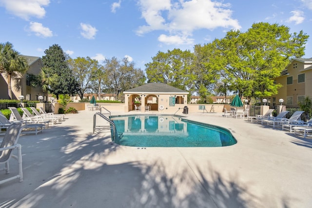 pool featuring a patio and fence