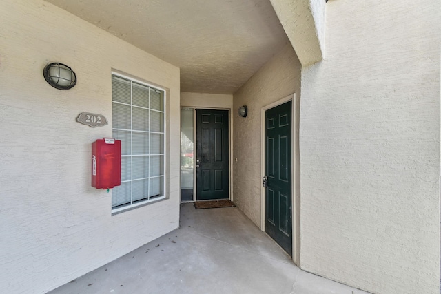 property entrance with stucco siding