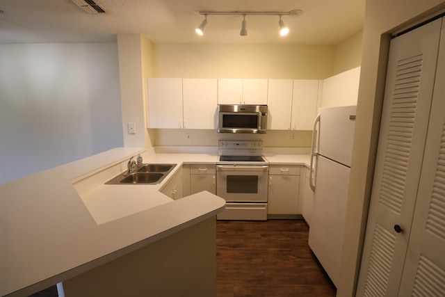 kitchen with sink, white cabinetry, dark hardwood / wood-style floors, kitchen peninsula, and white appliances