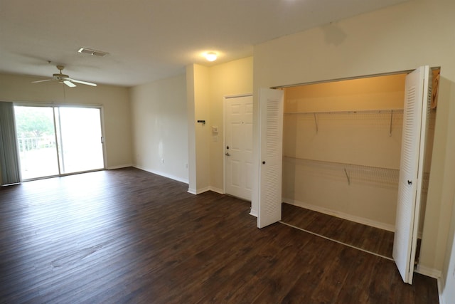 unfurnished bedroom with dark wood-type flooring, access to exterior, and a closet