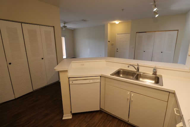 kitchen with kitchen peninsula, sink, dark hardwood / wood-style flooring, ceiling fan, and white dishwasher