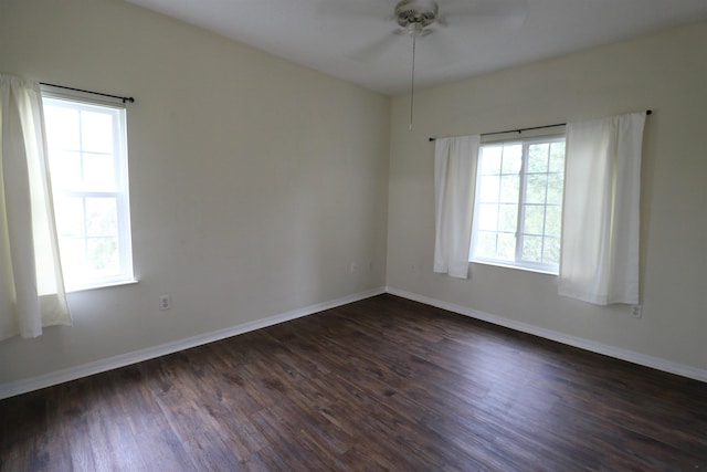 spare room featuring dark hardwood / wood-style flooring and ceiling fan