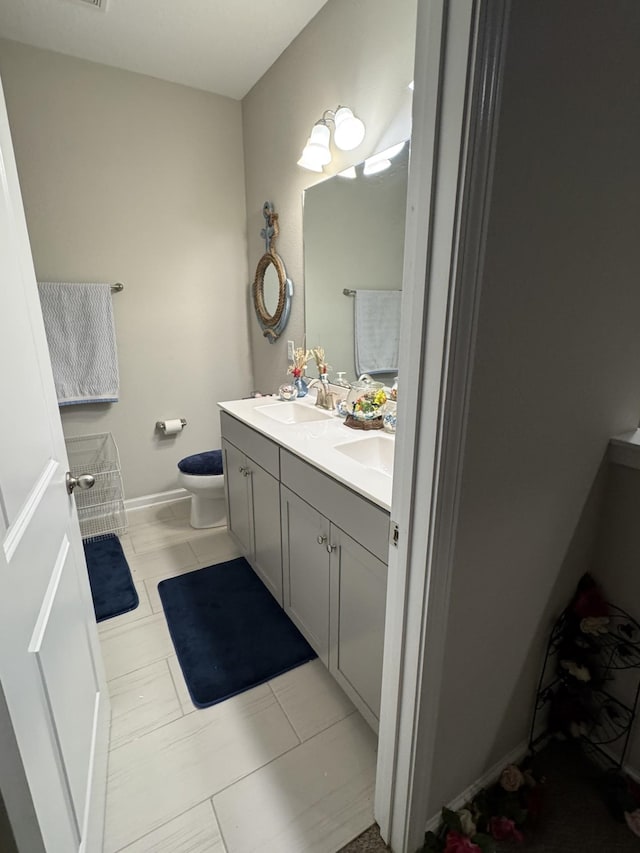 bathroom with vanity, tile patterned floors, and toilet