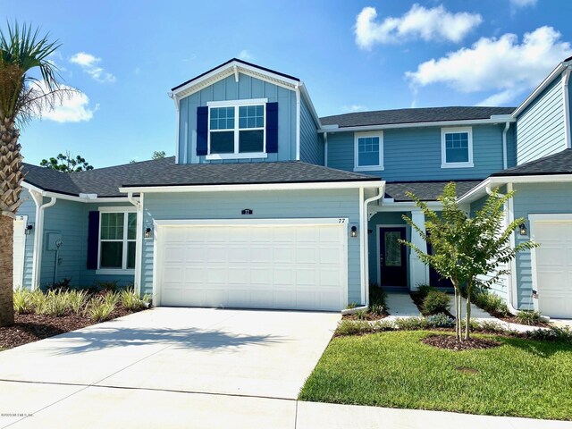 view of front of home featuring a garage and a front yard