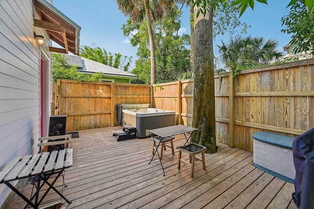 wooden terrace with a hot tub