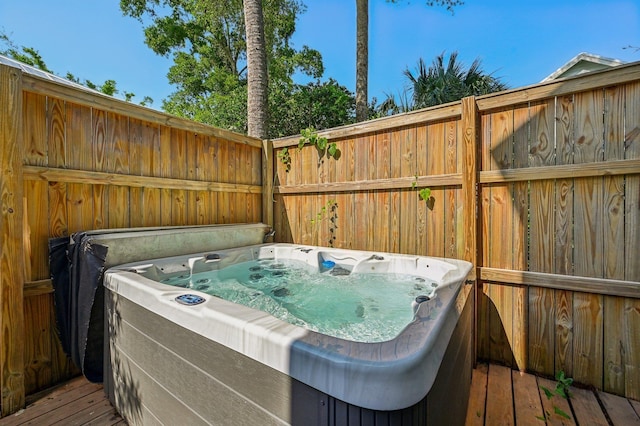 wooden terrace featuring a hot tub