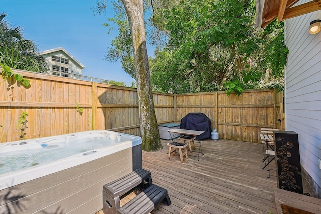 wooden deck with fence and a hot tub