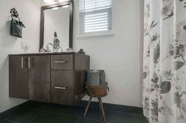 bathroom featuring a shower with shower curtain, tile patterned floors, and vanity