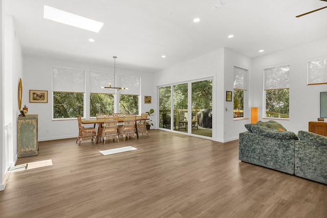 2470 Oleander St, Saint Augustine, FL 32080 - dining room with wood finished floors, a chandelier, recessed lighting, and a skylight