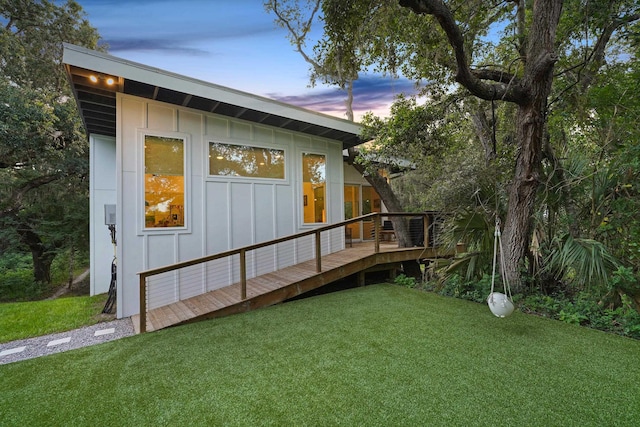 2470 Oleander St, Saint Augustine, FL 32080 - back of property featuring board and batten siding, a deck, and a lawn