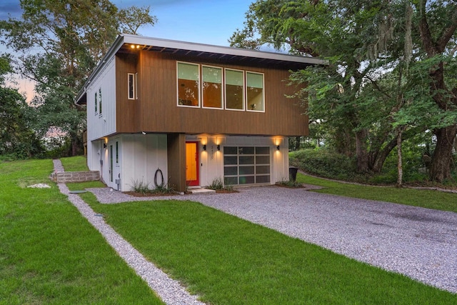 2470 Oleander St, Saint Augustine, FL 32080 - contemporary home with driveway, a garage, and a front lawn