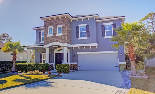 view of front of home featuring a front lawn and a garage