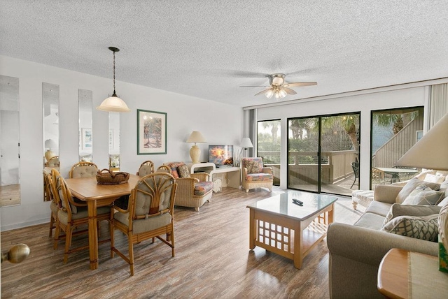 living room featuring ceiling fan, wood-type flooring, and a textured ceiling