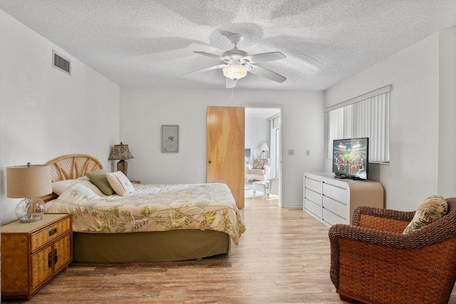 130 Ocean Hibiscus Dr Unit H 204, Saint Augustine, FL 32080 - bedroom with light wood finished floors, a textured ceiling, and a ceiling fan