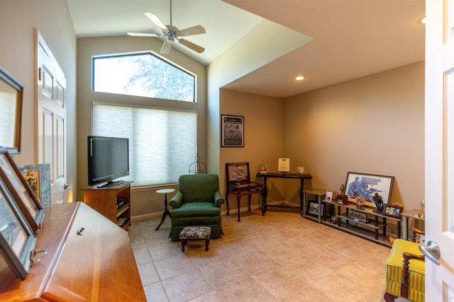 sitting room with high vaulted ceiling, ceiling fan, and light tile patterned flooring