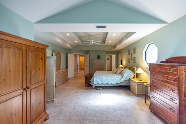 tiled bedroom with lofted ceiling and a tray ceiling